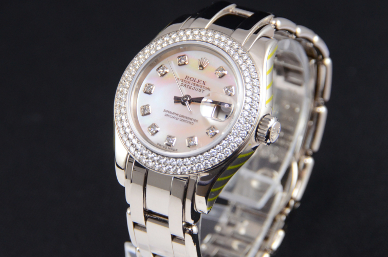Detail view of a white gold 29mm Rolex Pearlmaster 80339, with a diamond set bezel and a white mother of pearl diamond dot dial