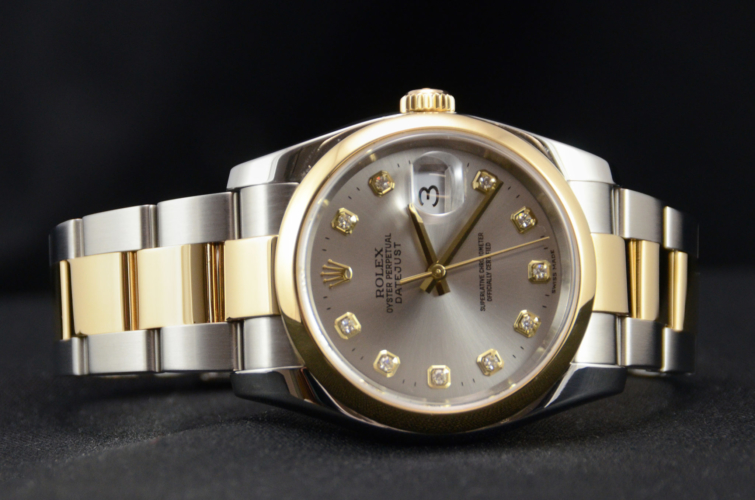 Detailed view image of a bimetal grey diamond dot dial Rolex Datejust 116203, with a yellow gold polished finish domed bezel and a stainless steel & yellow gold Oyster bracelet