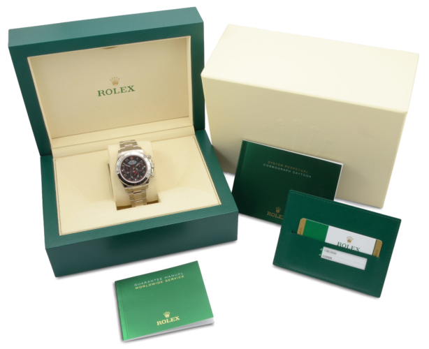 Box & papers image of a white gold 40mm Rolex Daytona 116509 featuring the desirable black & red racing dial