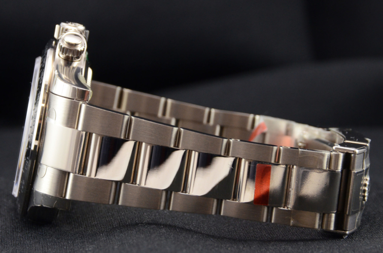 Detailed view image of a white gold 40mm Rolex Daytona 116509 featuring the desirable black & red racing dial