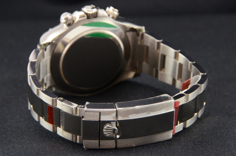 Detailed view image of a white gold 40mm Rolex Daytona 116509 featuring the desirable black & red racing dial