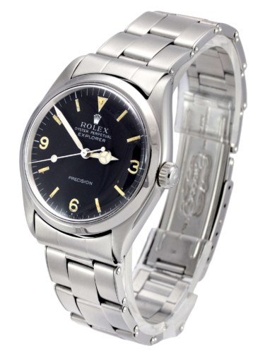 Side view image of a vintage stainless steel Rolex Explorer 5500 with a flexible riveted bracelet and aged patina on the dial