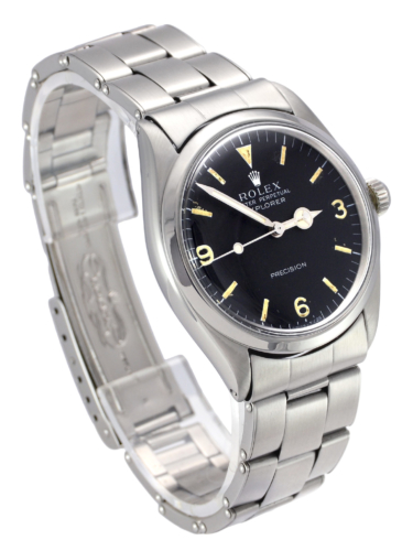 Side view image of a vintage stainless steel Rolex Explorer 5500 with a flexible riveted bracelet and aged patina on the dial