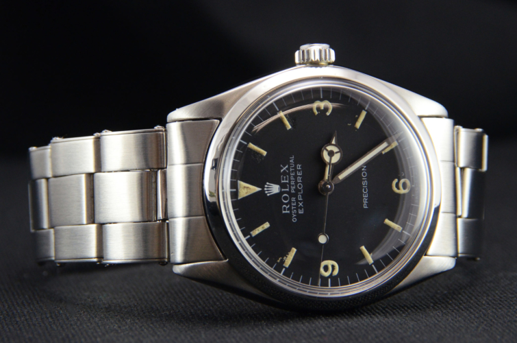 Detailed view image of a vintage stainless steel Rolex Explorer 5500 with a flexible riveted bracelet and aged patina on the dial