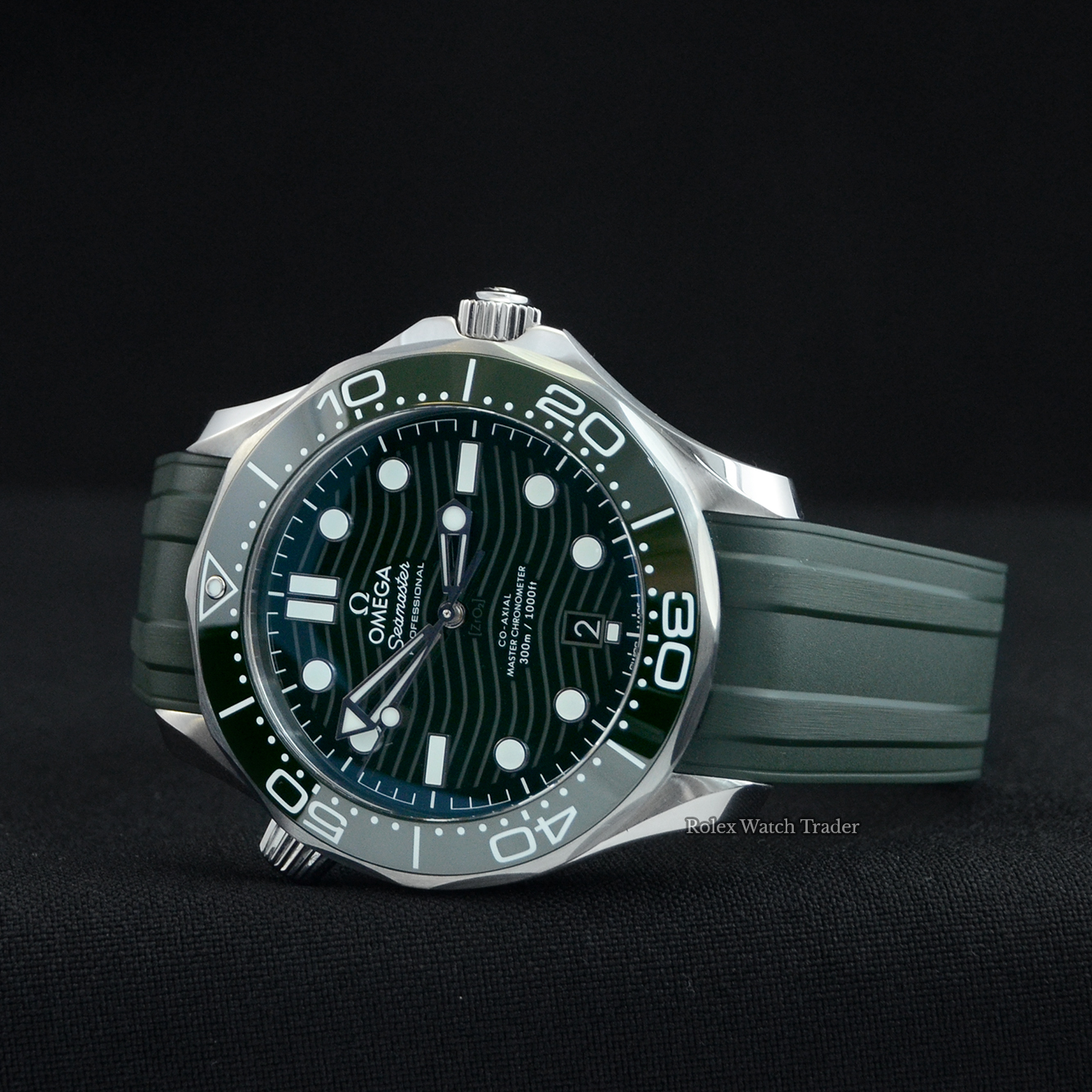 Overview of the watch resting on its case side Omega Diver 300M Co‑Axial Master Chronometer 42mm 2022 Unworn Green Dial For Sale Available Purchase Buy Online with Part Exchange or Direct Sale Manchester North West England UK Great Britain Buy Today Free Next Day Delivery Warranty Luxury Watch Watches
