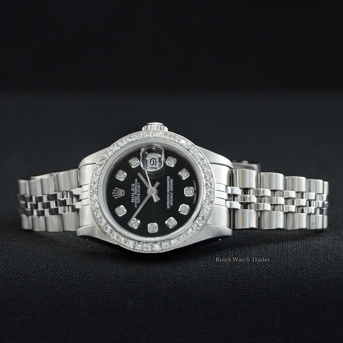 Overview of the watch resting on its case side Rolex Lady-Datejust 26mm 69174 Gem Set Bezel Black Diamond Dot Dial For Sale Available Purchase Buy Online with Part Exchange or Direct Sale Manchester North West England UK Great Britain Buy Today Free Next Day Delivery Warranty Luxury Watch Watches