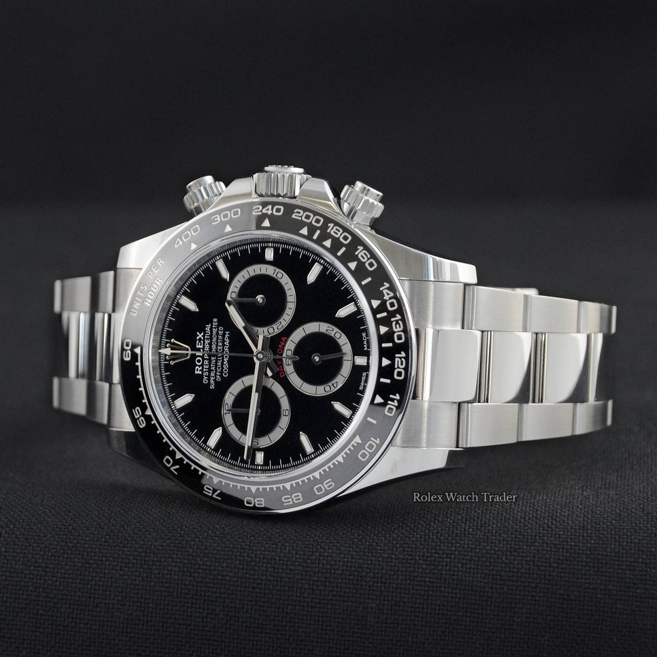 Overview of the watch resting on its case side Rolex Daytona 126500LN Unworn 12/23 Complete Set Immediate Dispatch For Sale Available Purchase Buy Online with Part Exchange or Direct Sale Manchester North West England UK Great Britain Buy Today Free Next Day Delivery Warranty Luxury Watch Watches